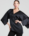 Take your style to epic proportions in a fluid Elie Tahari blouse flaunting exaggerated slit sleeves and a plunging neckline dripping with dazzle.