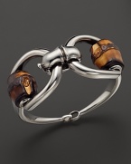 Striking and chic, this equestrian-inspired sterling silver horsebit bracelet features natural bamboo beads. By Gucci.