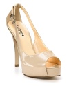 Subtle patent leather peeptoe pumps with cutout detail at heel.