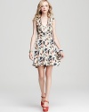 This Juicy Couture dress goes full-on feminine with decadent neckline ruffles and a playful iris print.