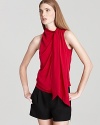 This richly colored DIANE von FURSTENBERG top is rendered in a gorgeously draped silhouette with cascading neck tie and open back.