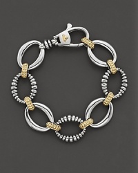 Sterling silver and 18 kt yellow gold, smooth and fluted oval link bracelet with lobster closure. Designed by Lagos.