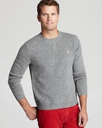 A traditional lambswool sweater is spruced up with a stitched V accent under the front collar and an owl applique logo on the chest.