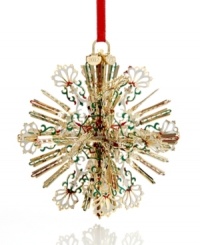 A burst of holiday brilliance, this radiant snowflake ornaments your tree with intricate spokes of gold-plated brass and flourishes of red, white and green. With 2012 hangtag.