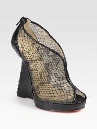 Backed by an exposed zipper, this python wedge has a slight platform, python trim and a semi-sheer lace and mesh upper. Python wedge, 5 (125mm)Python platform, 1 (25mm)Compares to a 4 heel (100mm)Python, mesh and lace upperBack zipperLeather liningSignature red leather solePadded insoleMade in ItalyOUR FIT MODEL RECOMMENDS ordering one size up as this style runs small. 