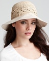 A hand rolled raffia bucket hat with braided detail and a lightweight cotton brim.