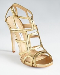 Geometric cutouts lend graphic appeal to DIANE von FURSTENBERG's Jeanette sandals, a strappy shoe that's glam in gold.