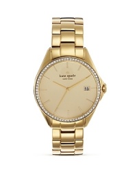 A crystal-encrusted bezel adds luxe sparkle to this gold-plated stainless steel watch from kate spade new york.