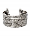 Go for a look that's completely retro-fitted. Vintage-inspired color creates a look of effortless cool in textured, oxidized silver tone mixed metal. Open cuff design slips easily over the wrist. Approximate diameter: 1-1/2 inches.