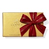 A classic assortment of Belgian chocolates from Godiva comes in a beautiful gold box tied with big red bow and holiday pick. Each ballotin includes Godiva signature favorite ganaches, pralines, caramels, fruits and nuts in milk, dark and white chocolate.