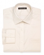 A regular fit Michael Kors non-iron dress shirt featuring a spread collar, barrel cuffs and a left chest pocket.