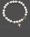 A petite pearl bracelet offers a traditional way to show your faith. This bracelet for children features a delicate strand of cultured freshwater pearls (5-6 mm) with a 14k gold dangling cross charm and accent beads. Set in 14k gold. Approximate length: 6 inches. Approximate drop: 1/2 inch.