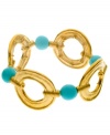 Make a splash year round! T Tahari's chic stretch bracelet highlights cut-out circles and resin beads in turquoise hues. Crafted in antique gold tone mixed metal. Bracelet stretches to fit wrist. Approximate diameter: 2-1/4 inches.