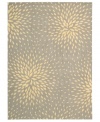 A chic starburst pattern adorns this stylish rug from the Capri collection, offering a unique focal point for any room. Woven of a blend of fine wool with Nourison's signature light-reflecting Luxcelle™ fibers, the rug's soft grey shade and luminous appearance complement a range of decors. (Clearance)