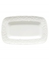 An elegant white-on-white pattern featuring an embossed vine motif and interior glaze lends the Opal Innocence Carved hors d'oeuvres tray to refined dining every day.