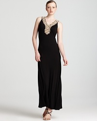 With an embellished neckline and a fluid black silhouette, this Calvin Klein maxi dress will take your look in an elegant direction. Team with sandals and gold accents for goddess-like glamour.