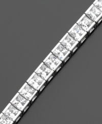 A beautiful tennis bracelet with a sophisticated air. Gorgeous princess-cut cubic zirconias (9 ct. t.w.) are set in sterling silver finished in platinum, by CRISLU. Approximate length: 7 inches.