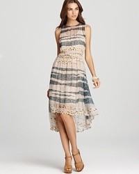 An abstract print lends an artsy sensibility to this Sam & Lavi dress, cut with a flowing high/low hem.