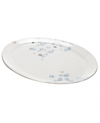 Breezy florals scatter on the white bone china of this Water Blossoms oval platter, suffusing your table with effortless grace. With shimmering platinum petals and banding for an especially pretty table. From Martha Stewart Collection.