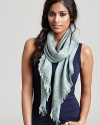 An elegant Tory Burch woven scarf with subtle logo print all over.