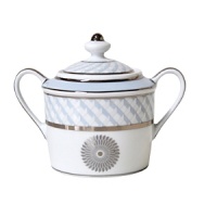 Carefully rendered in a style reminiscent of neoclassic trompe l'oeil-a French term for artwork that depicts optical illusions-a captivating geometric rosette motif traverses this elegant porcelain sugar bowl from Bernardaud. Delicate shades of ice blue, mother-of-pearl and gray are enhanced by fine platinum details.