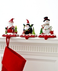 A stocking full of personality. Topped with a clay figurine of a penguin, Santa or snowman, these too-cute stocking holders keep gifts hanging, balancing the weight on a cast iron base.