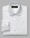 Classic dress shirt with spread collar and two pockets. Button front closure. Made with a little stretch that will move with him and retain its shape after washing.