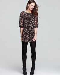 Cut in an abbreviated silhouette, this Free People mini dress flaunts a pretty floral print. Wear it on balmy evenings with metallic sandals and chilly days with opaque tights and booties.