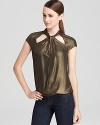 Let this BCBGMAXAZRIA top take you on a gilt trip with its must-have metallic shine. Pair with jeans or black skinny pants, and you're golden.