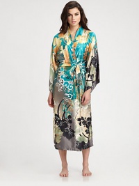 Luxurious silky-smooth fabric takes on a beautiful floral print in refreshing, tropical hues. V-neckDropped shouldersThree-quarter kimono sleevesSelf-tie waistAbout 49 from shoulder to hemPolyesterMachine washImported