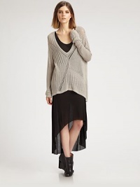 An oversized knit that doesn't lose its femininity, thanks to a creative open back and chic high-low hem.Plunging v-neckLong sleevesHigh-low hemCrossover detail on open backAbout 34 from shoulder to hem65% viscose/35% polyesterDry cleanImported of Italian fabricModel shown is 5'10 (177cm) wearing US size Small.