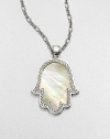 A mano di fatima pendant in iridescent mother-of-pearl surrounded by intricately designed sterling silver on a link chain. Mother-of-pearlSterling silverLength, about 18 to 20 adjustablePendant size, about 2.5Lobster claspImported 