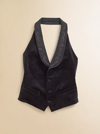 A fitted tuxedo vest is tailored in luxurious velvet with classic detailing and an embroidered twill collar for a heritage-inspired look.Twill shawl collarSleevelessHalter silhouetteFour-button frontWelt pockets at hips and chestAdjustable back tabViscose/SilkDry cleanImportedHeadband shown not sold Please note: Number of buttons may vary depending on size ordered. 