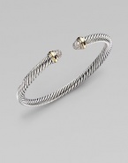 A signature Yurman cable of sterling silver, richly enhanced by bands of 18k yellow gold, encircling pavé diamond domed end caps. Diamonds, 0.30 tcw Sterling silver and 18k yellow gold Cable, 5mm Diameter, about 2½ Made in USA