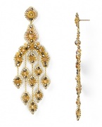 An ornate cascade formed from beautiful 14-karat gold, Swarovski crystals, and topaz accents, Miguel Ases' gleaming chandelier earrings are a captivating jewelry choice.