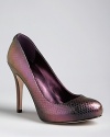 Snake-embossed leather is sensational in an iridescent plum that gleams gold and green. These IVANKA TRUMP pumps are perfect for work or after hours.