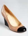 All out classic, these kate spade new york wedges defy time with a timeless blush and black colorway and iconic cap toe.