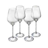 Hundreds of crystals sparkle on the stems of these glittering white wine glasses, while a faceted crystal base reflects light. From Swarovski.