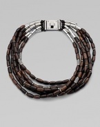 Beautifully textured, wooden beads with a sprinkle of rhinestone encrusted beads on leather cords in a chunky multi-row design. WoodLeatherBrassGlass stonesLength, about 20Logo accented turn-lock closureImported 