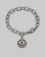 Bold, textured links of sterling silver hold a protective evil eye charm, radiantly created of white, blue and black sapphires with a touch of 18k gold. Sapphires Sterling silver and 18k yellow gold Bracelet length, about 7½ Charm diameter, about ¾ Heart-shaped lobster clasp Made in USA