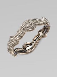 A beautifully curvy design in plated rhodium. Brass Hinged, box and tongue closure Diameter, about 2¼ Width, about ½ Imported 