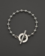 A bold toggle closure finishes this sterling silver circle bracelet.