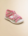 Vibrant flowers and contrasting trim adorn these sweet little t-strap sandals for baby.Adjustable buckle and grip-tape closureCanvas upperCanvas liningRubber solePadded insoleImported