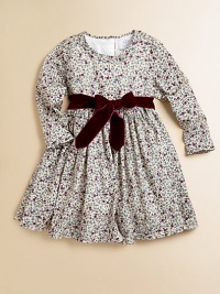 Blooming with a vivid floral print and a velvet tie, this delightful cotton frock will make your little one feel like a flower girl.Ruffled round necklineLong sleevesBack buttonsWaistband with velvet ribbon tieFull skirtFully linedCottonMachine washImported Please note: Number of buttons may vary depending on size ordered. 