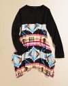 A split, asymmetrical hemmed skirt is complimented by an eye-catching tribal print and topped with a solid shirt for a California cool ensemble.CrewneckLong sleevesPullover styleHigh-waistedSplit asymmetrical hem85% rayon/15% spandexHand washImported