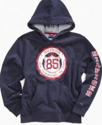 The easy way to go back – this classic pullover hoodie from Tommy Hilfiger helps warm up his casual looks this fall.