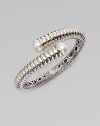 From the Bedeg Collection. A richly ribbed hinged cuff of gleaming sterling silver with accents of 18k gold has overlapping endcaps set with lustrous pearls.White pearlsSterling silver and 18k yellow goldDiameter, about 2¼Width, about ½HingedImported