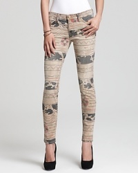 Update your fall denim wardrobe with distressed, tribal-print Current/Elliott cropped skinny jeans.