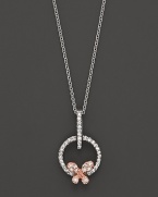 A dainty diamond butterfly pendant set in 14K. rose and white gold.