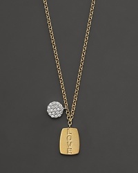 This gold necklace is engraved with LOVE and is paired with a diamond pavé medallion. Designed by Meira T.